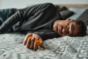 man passed out on bed - nodding off heroin