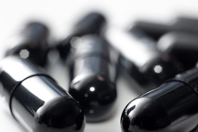 close up of black pill capsules - black beauty drug black beauties pills